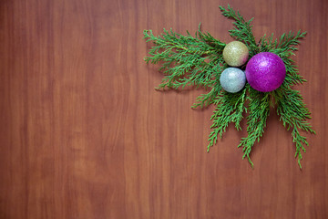 Christmas wooden background with fir branches and balls. New Year's decoration.