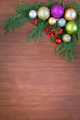Christmas wooden background with fir branches and balls. New Year's decoration.