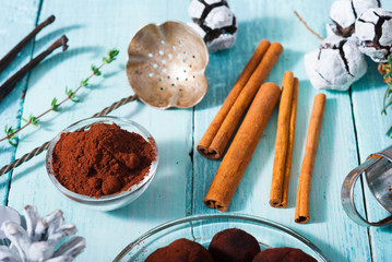 Christmas chocolate truffles and spices on shabby chic blue wood table