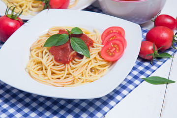 Spaghetti pasta with and tomato sauce on wood background
