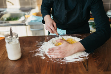 Obraz na płótnie Canvas Chef making fresh pasta in the kitchen