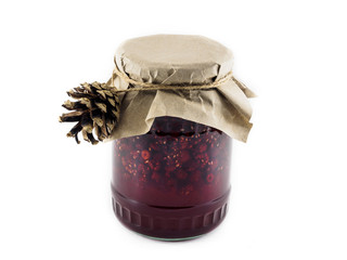 Useful raspberry jam in a glass jar. Natural treatment and traditional medicine. Jam on white...