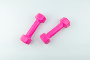 Two pink dumbbells isolated on white background.