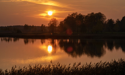 Fototapeta premium beautiful sunset by the lake, foggy sky, autumn evening
