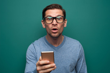 Portrait of a shocked young man in a sweater