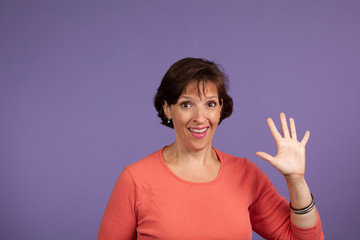 iddle Age Woman holding up five fingers