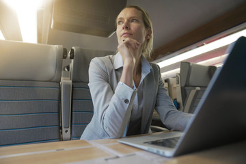 businesswoman working on a train in business class