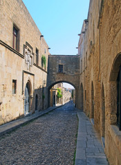 Fototapeta na wymiar view of the street of the knights of rhodes lined with medieval buildings and an archway joining buildings