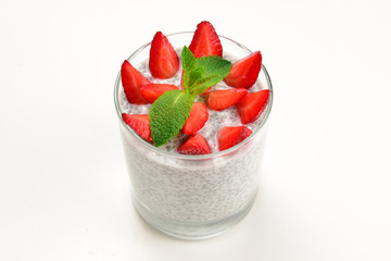 Chia pudding with strawberry and mint on a white background. Space for text or design.