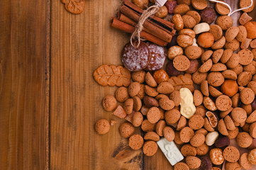 A traditional Dutch holiday for children of Sinterklaas. Winter holidays in Europe and the Netherlands. background with pepernoten and traditional strooigoed sweets. Form for writing text. Flat lay.