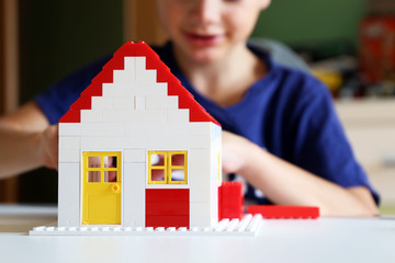 Boy builds his dream house with building blocks