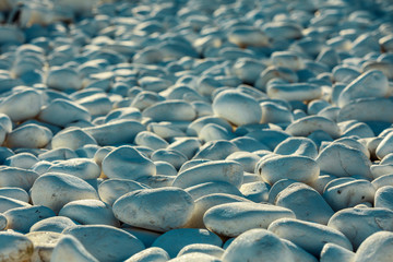 Fototapeta na wymiar white smooth washed stones with a cool hue.