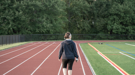 Fototapeta premium Middle age woman staying fit on track