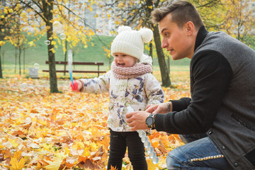 Dad and his daughter are making bubbles