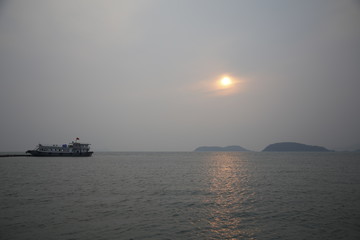 Obraz premium Sunset in a harbor of Bai Tu Long Bay, Vietnam