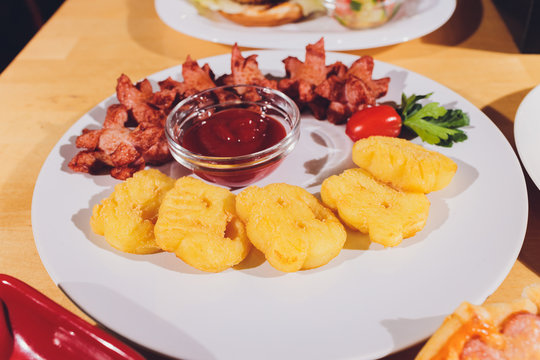 Child food. Funny food. Plate with cutlets and mashed potatoes in the form of a monkey faces. Children's menu.