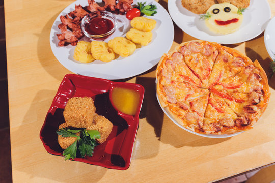 Child food. Funny food. Plate with cutlets and mashed potatoes in the form of a monkey faces. Children's menu.
