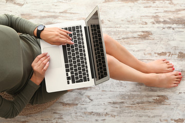 Young woman working on laptop at home