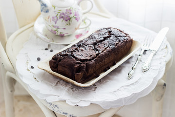 Tea service with banana bread over a white table cloth 