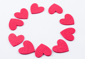 Fototapeta premium Red crafting foam hearts in white background. Decor hearts by cutting from red crafting foam