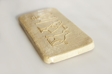 Fototapeta premium clay tablet with the inscription cat in ancient egyptian. modern handwork. hieroglyph cat