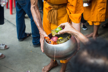 Buddhist monks are given food offering from people for End of Buddhist Lent Day