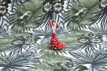 flamenco dancer figurine on a tropical motif background