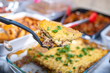 A piece of some pie being dished into a plate