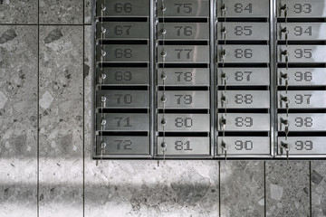 Numbered metal mailboxes with keys in them