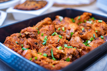 A food bowl of peppered chicken