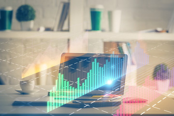 Stock market graph on background with desk and personal computer. Multi exposure. Concept of financial analysis.