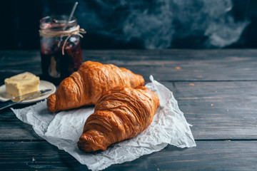delicious croissants on wooden table