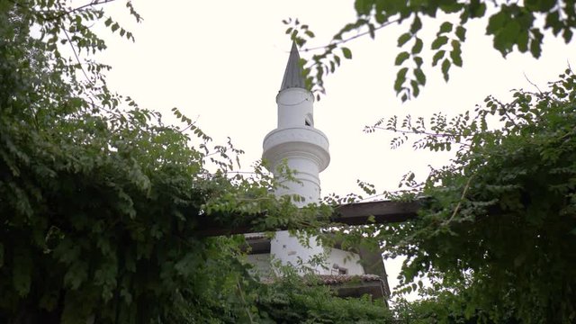 Balchik Palace or Quiet Nest Palace, approaching the historic building with the white minaret on the coast of Black Sea, summer residence of Queen Marie of Romania, in Balchick, Bulgaria
