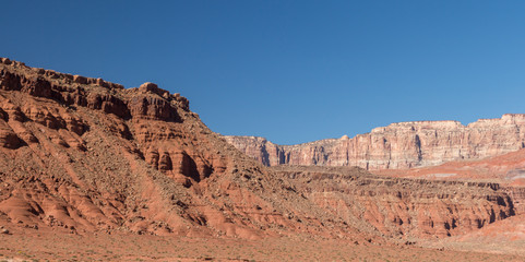 Glen Canyon bluffs under a blue sky