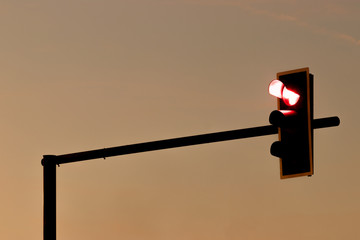 The red traffic lights have a background image of the sky in the evening.