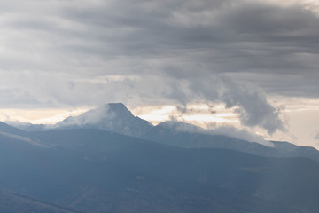 mountain covered by white clouds