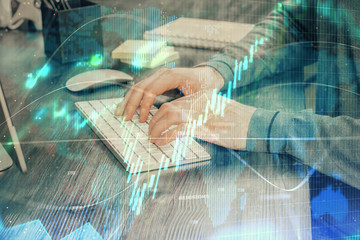 Multi exposure of financial graph with man works in office on background. Concept of analysis.