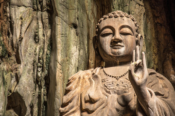 A Buddha with the peace symbol inside the Marble Mountains of Da Nang, positioned on the right