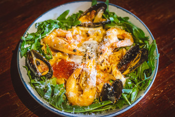 Pink sauce pasta (a mixture of Pomodoro and Carbonara), Grated Parmesan, Extra Virgin Olive Oil, Arugula, Sous Vide Egg, Calamari, Black Lump Fish Caviar, Black Truffle Pate, Prawns