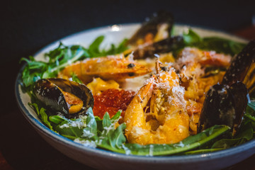 Pink sauce pasta (a mixture of Pomodoro and Carbonara), Grated Parmesan, Extra Virgin Olive Oil, Arugula, Sous Vide Egg, Calamari, Black Lump Fish Caviar, Black Truffle Pate, Prawns