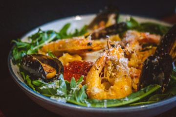 Pink sauce pasta (a mixture of Pomodoro and Carbonara), Grated Parmesan, Extra Virgin Olive Oil, Arugula, Sous Vide Egg, Calamari, Black Lump Fish Caviar, Black Truffle Pate, Prawns