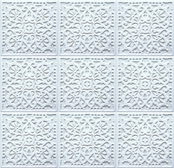 Ceramic tiles with floral and geometric patterns. Ligth texture for wall design. Seamless ornaments on concrete background.