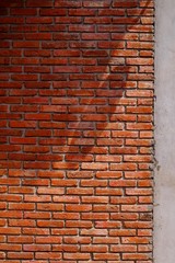 aged street brick wall with shadow