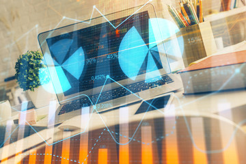 Fototapeta na wymiar Financial graph colorful drawing and table with computer on background. Multi exposure. Concept of international markets.