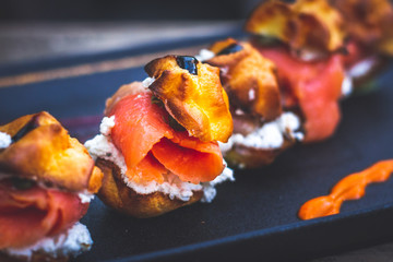 Delicias De Salmon with smoked salmon, Cream cheese, capers, profiteroles rellenos