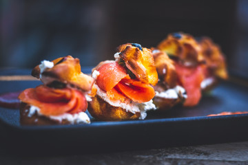 Delicias De Salmon with smoked salmon, Cream cheese, capers, profiteroles rellenos