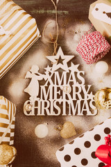 Studio shot of a beautiful decoration for christmas on a rustic blue background, top view, flat lay,snow sprayed above, christmas and winter holidays concept.