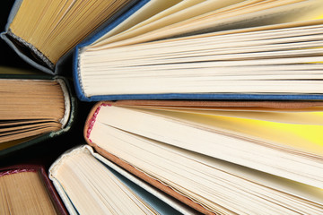 Hardcover old books as background, top view