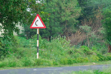 Curve road sign, signal turn right on bridge.