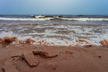 cold waves coming to the sandy shore